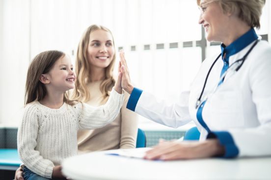 Clinical image: A child sharing a smile with a doctor